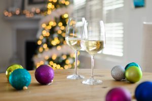 Glasses of wine on table with holiday decorations