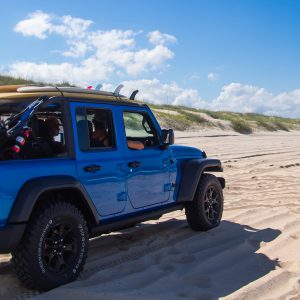 Jeep driving up beach in Carova